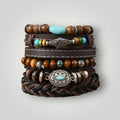 A stack of five western-style leather bracelets with wooden beads, turquoise accents, silver-toned metal spacers, and a braided leather base, photographed on a light gray background.