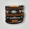 A stack of nine bohemian-style leather bracelets in various braided and woven patterns, featuring brown, tan, and black cords, turquoise beads, and silver-toned metal accents.