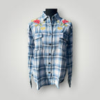 A blue and white plaid button-up shirt with red floral embroidery on the shoulders, displayed on a black mannequin torso against a light gray background.