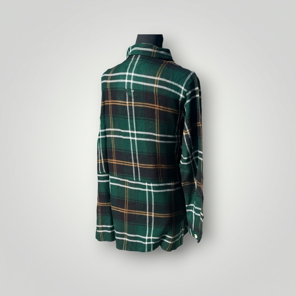 A green plaid long-sleeve flannel shirt displayed on a black mannequin torso against a light gray background.